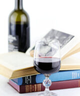 Independent Wine official crystal goblet with books and bottle of red wine