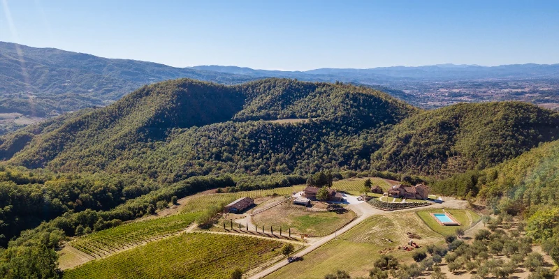 Drone view of the Borgo Macereto winery and agriturismo in the mountain amphitheatre north of Dicomano, Firenze, Toscana